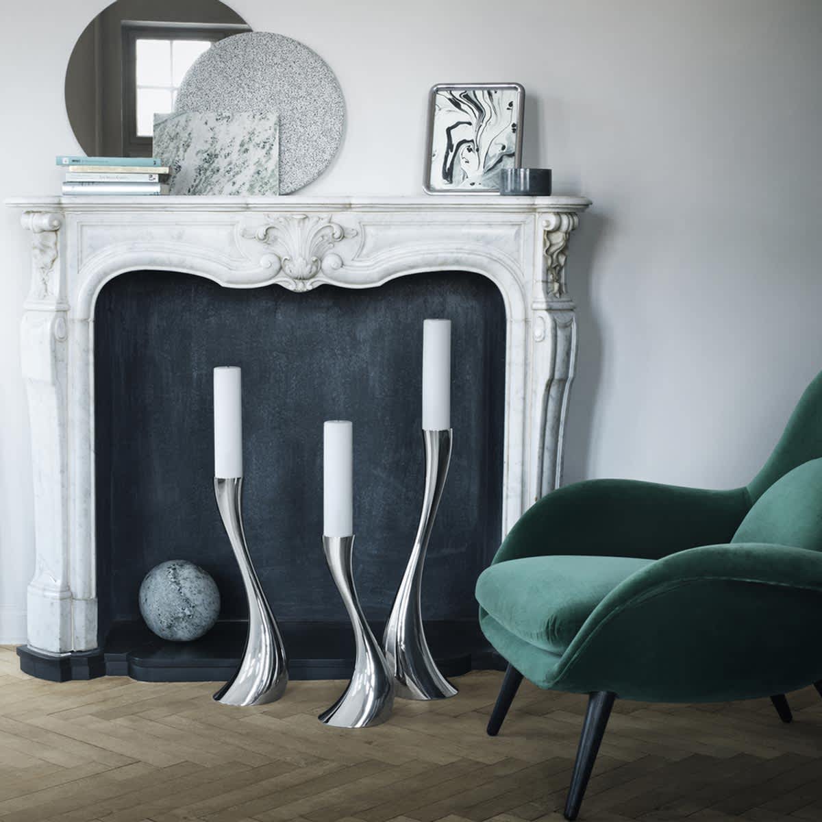 Floor candleholders styled by a fireplace