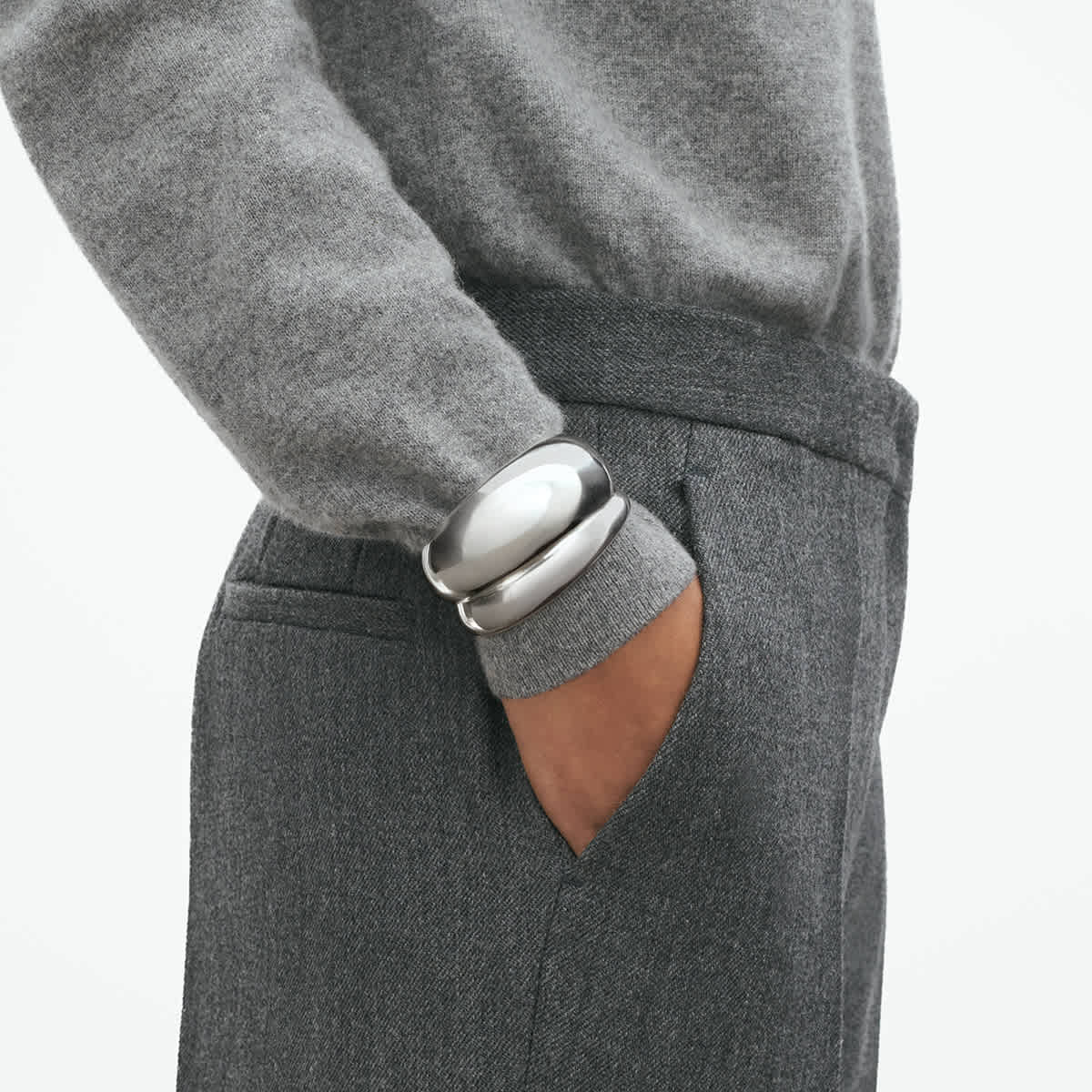 Close-up of the bangle's rounded silver volume