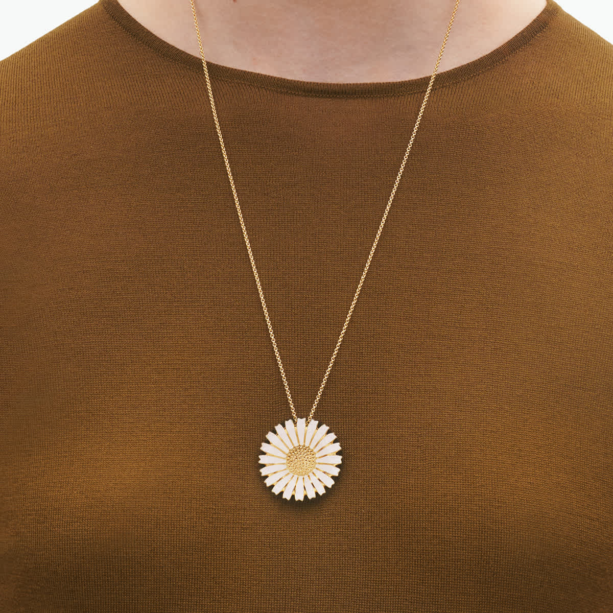 Daisy pendant worn on a fine chain