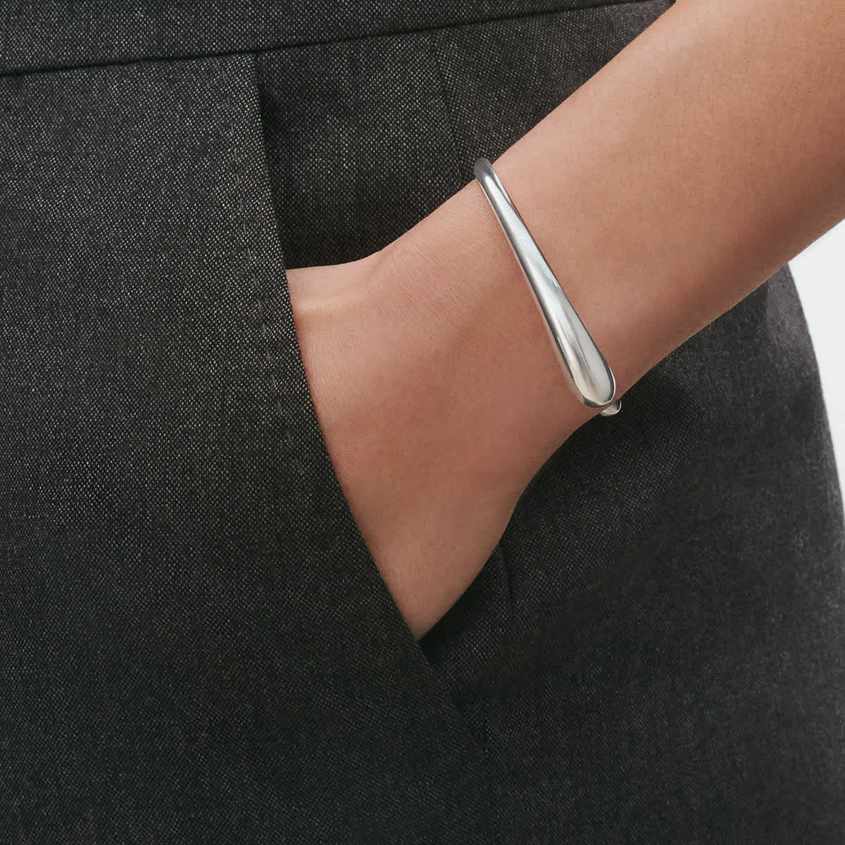 Close-up of the open silver strand on wrist