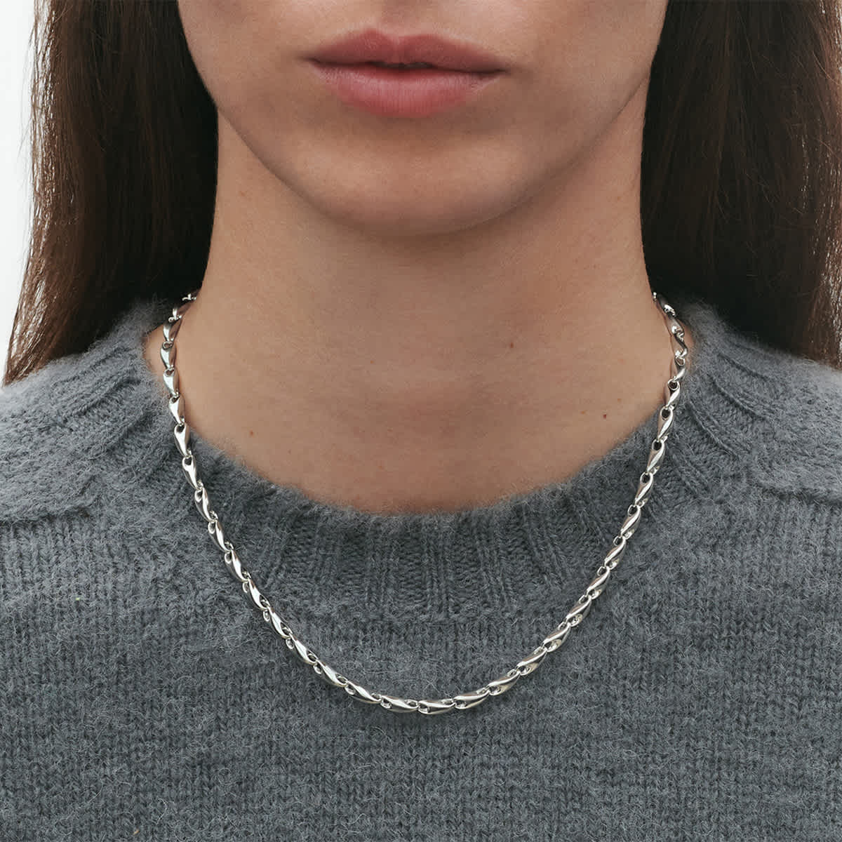Reflect necklace worn close to the collarbone