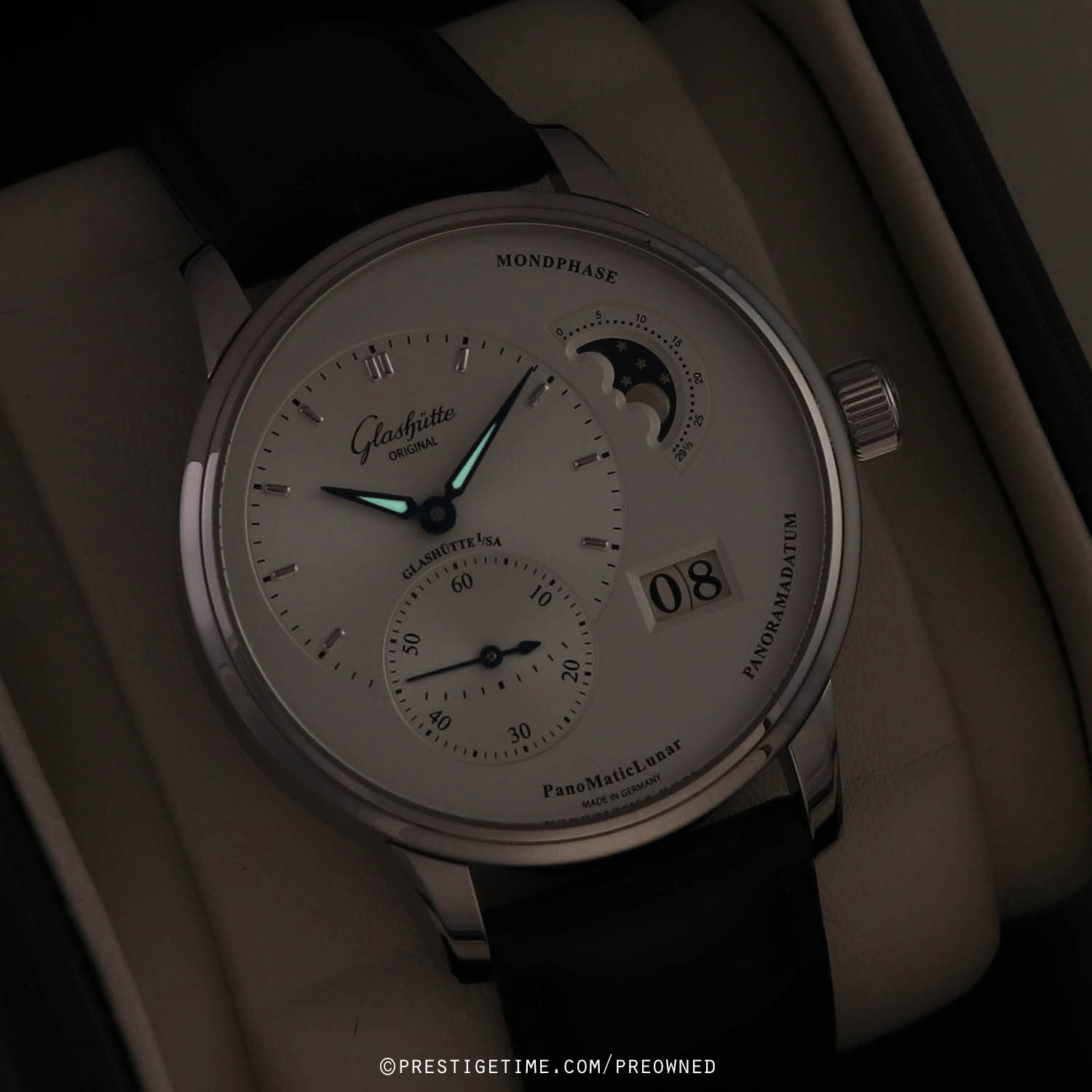 Low-key dial view showing the moon phase and signature date aperture
