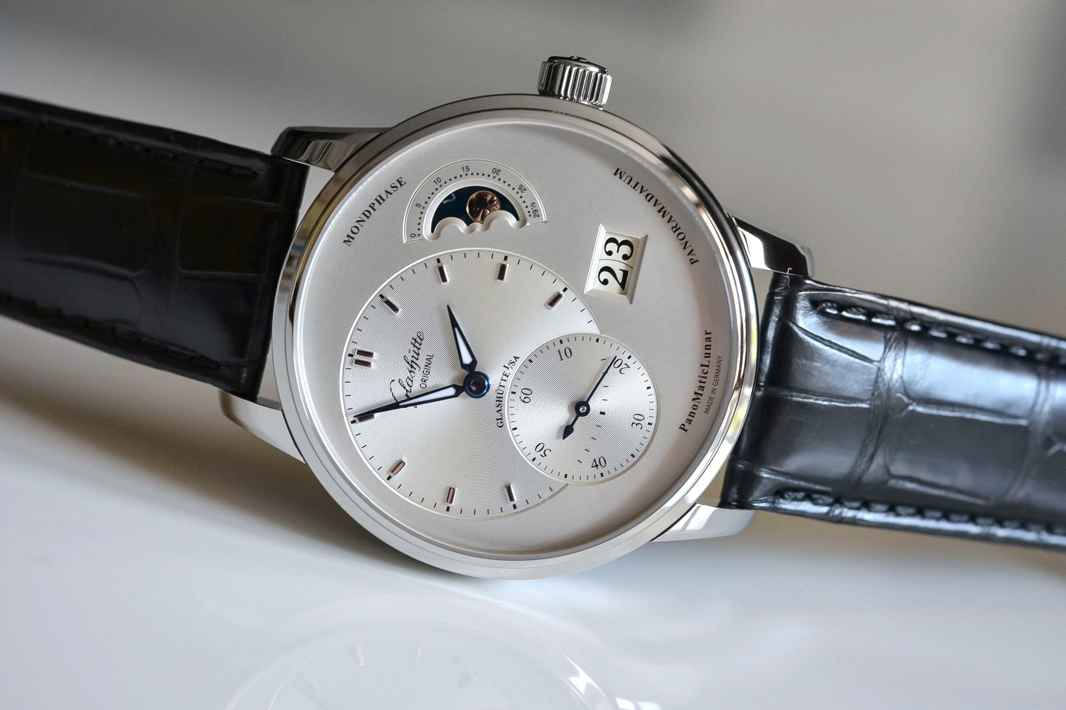 Three-quarter angle highlighting the polished case and blue hands