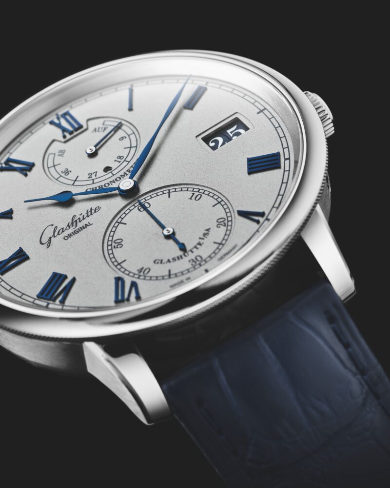 Dial close-up with Roman numerals and blue strap