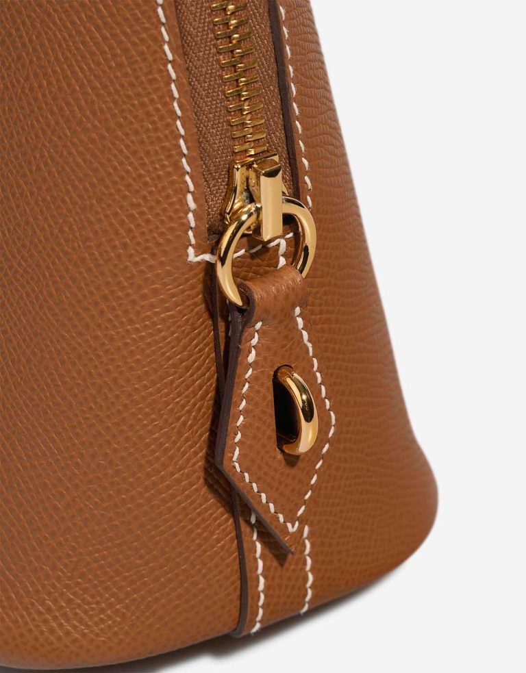Close detail of the zipper hardware and saddle-stitched seams