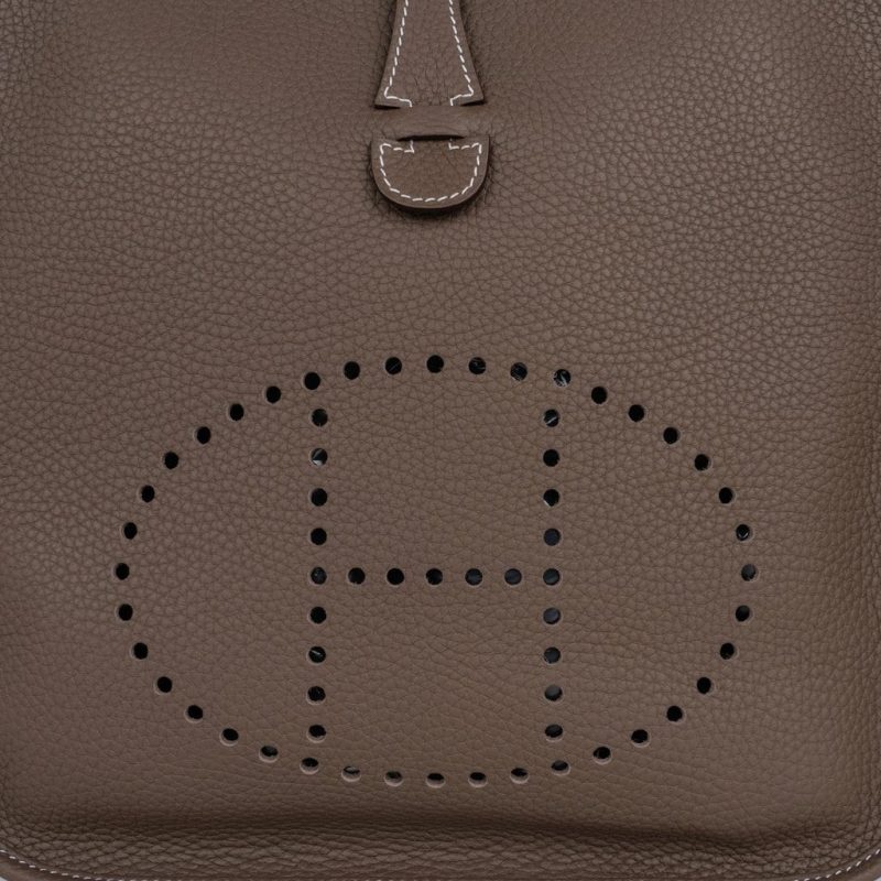 Close detail of the perforated H motif punched into étoupe Clemence