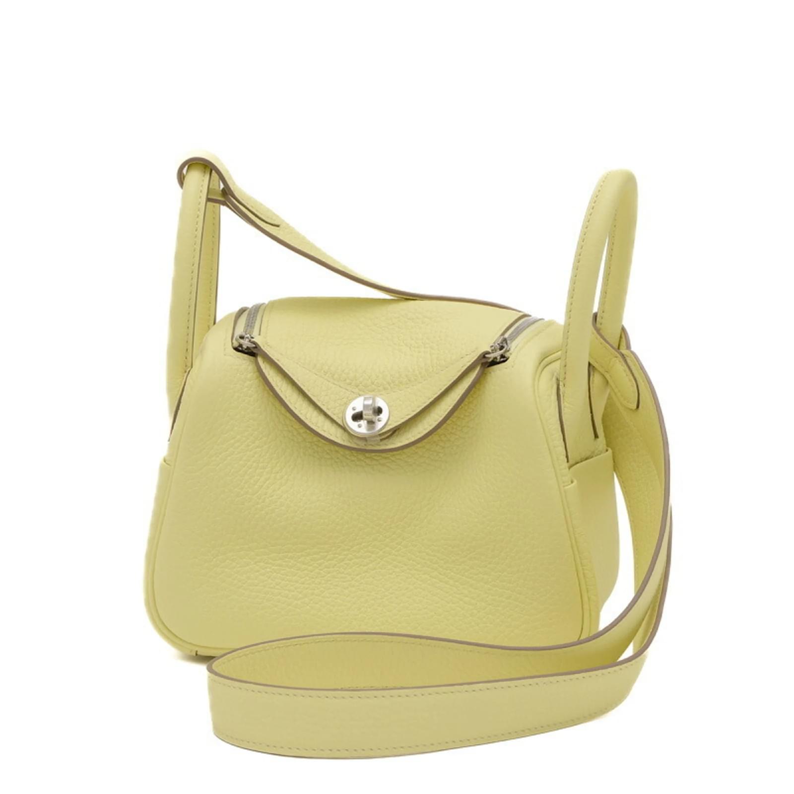 Mini Lindy in lemon Clemence on its crossbody strap