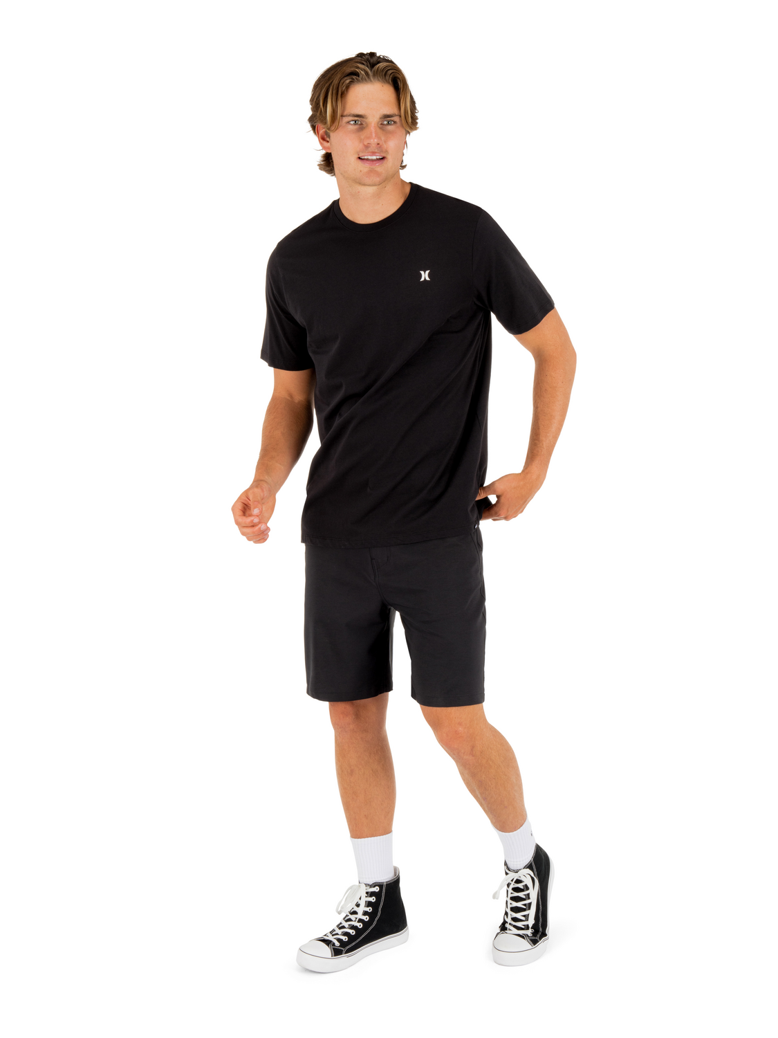 Styled view showing the minimal chest logo in wear.