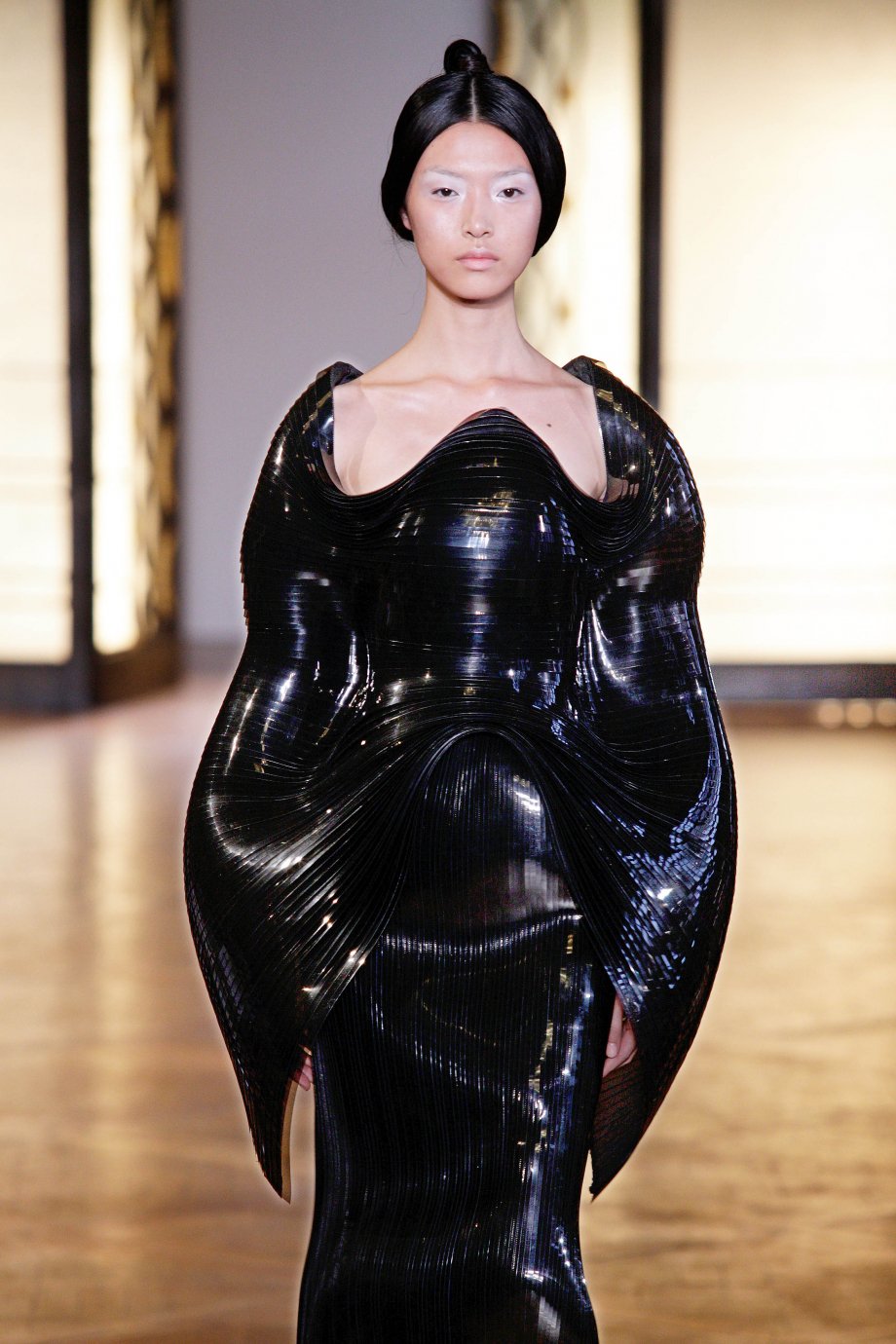 A tessellated coat-like silhouette from the runway