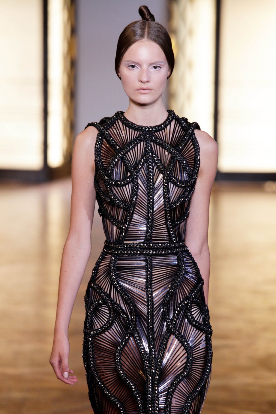 Black lacquered volume set against a sharply engineered torso