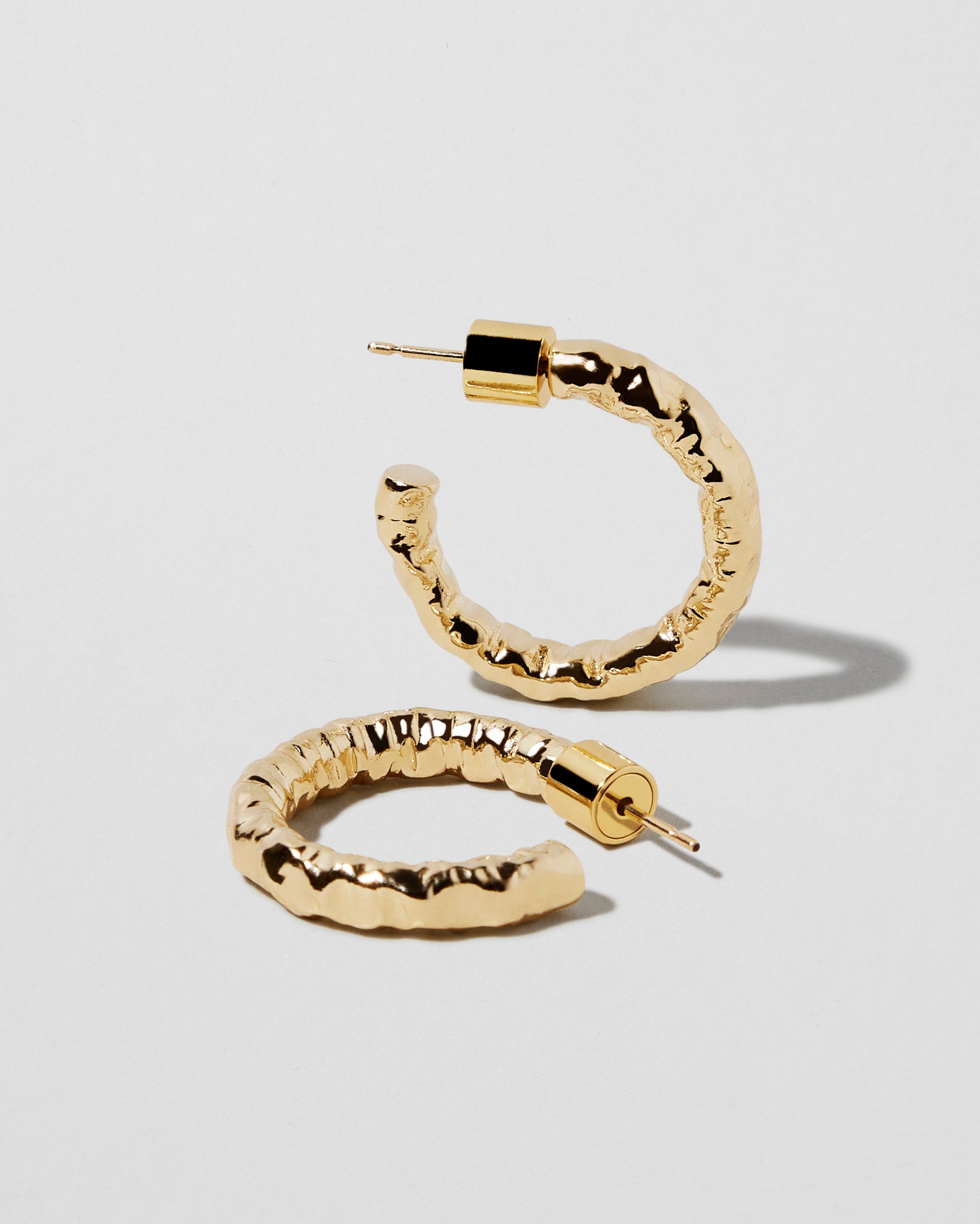 Gold angled pair showing the irregular texture and rounded body