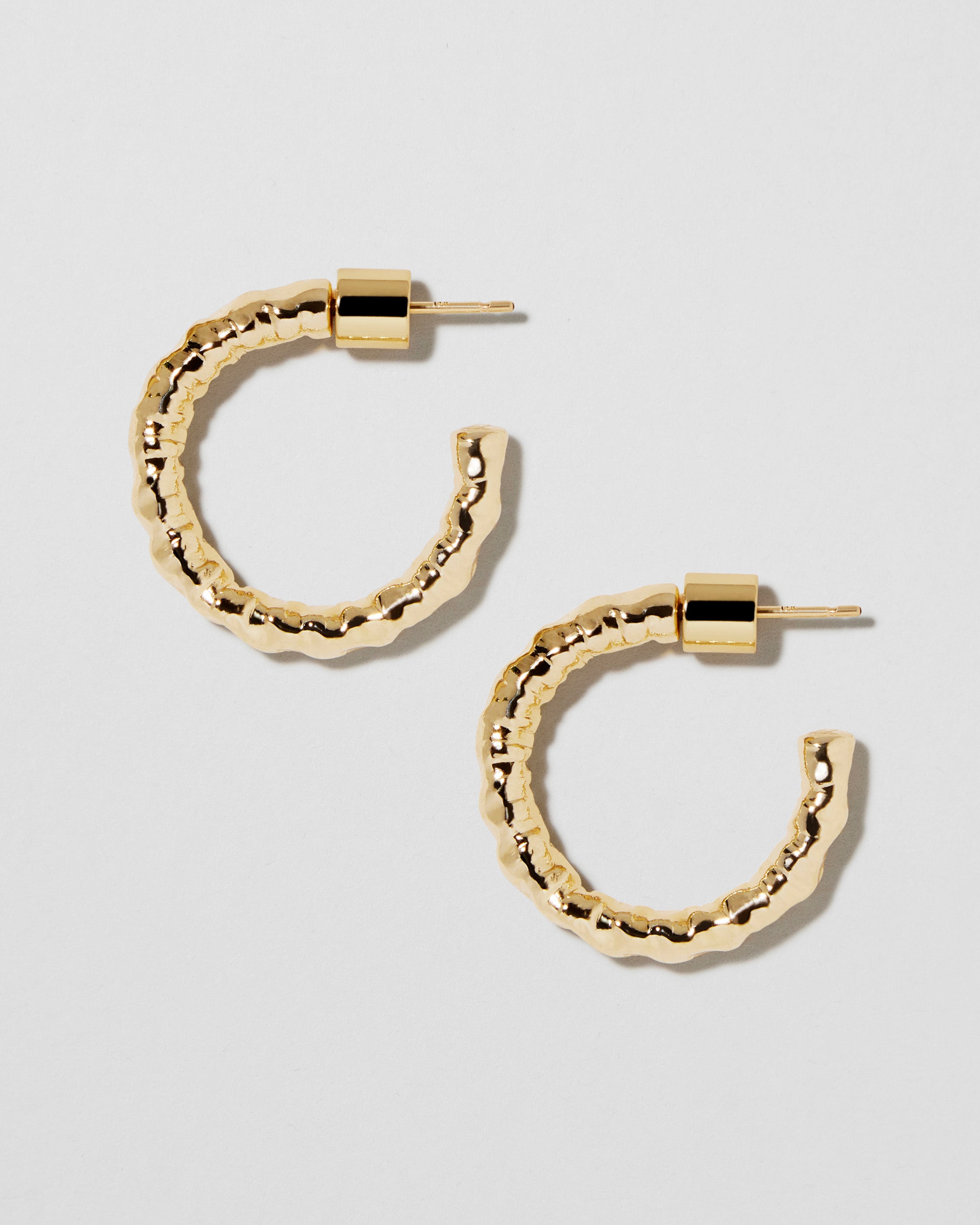 Front-facing gold pair with the hammered texture emphasized