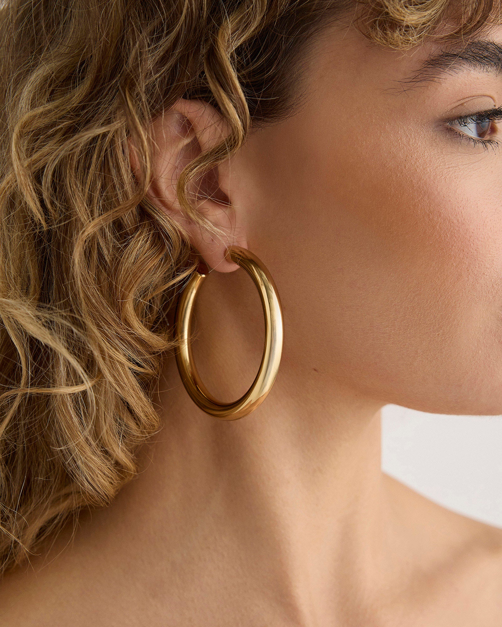 Alternate on-ear view of the 2-inch Samira as a daily statement hoop