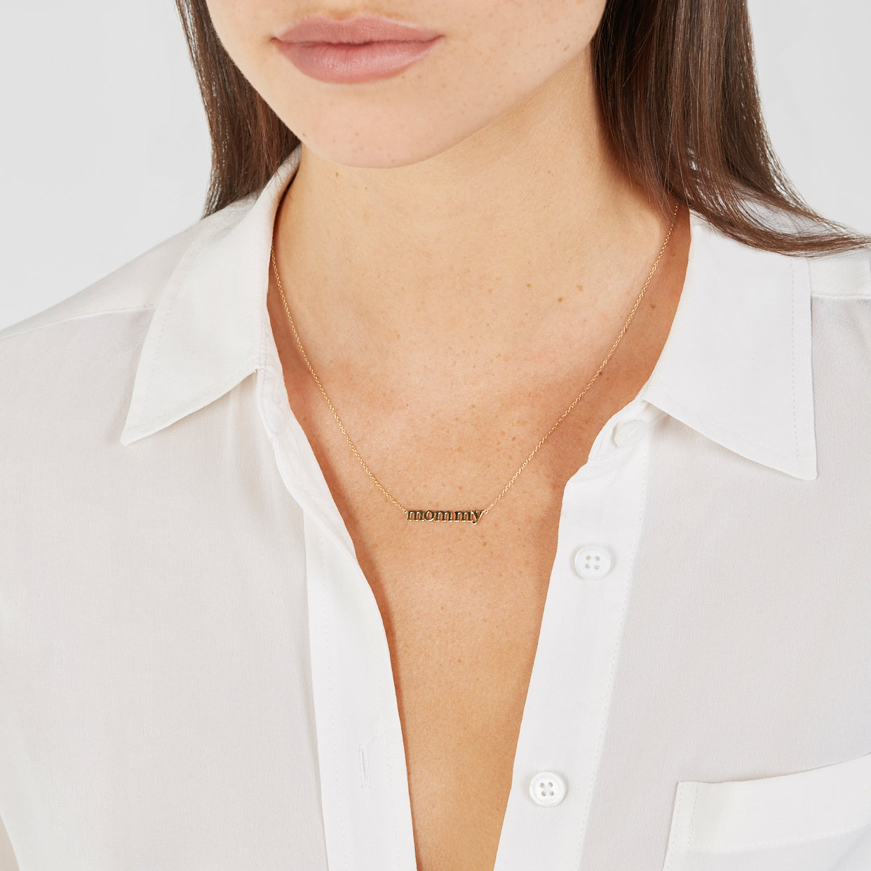 Close crop showing the word laid flat at the collarbone
