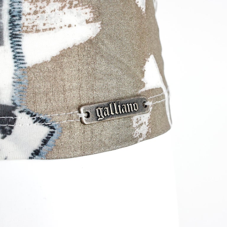 Hem close-up with Galliano plaque detail