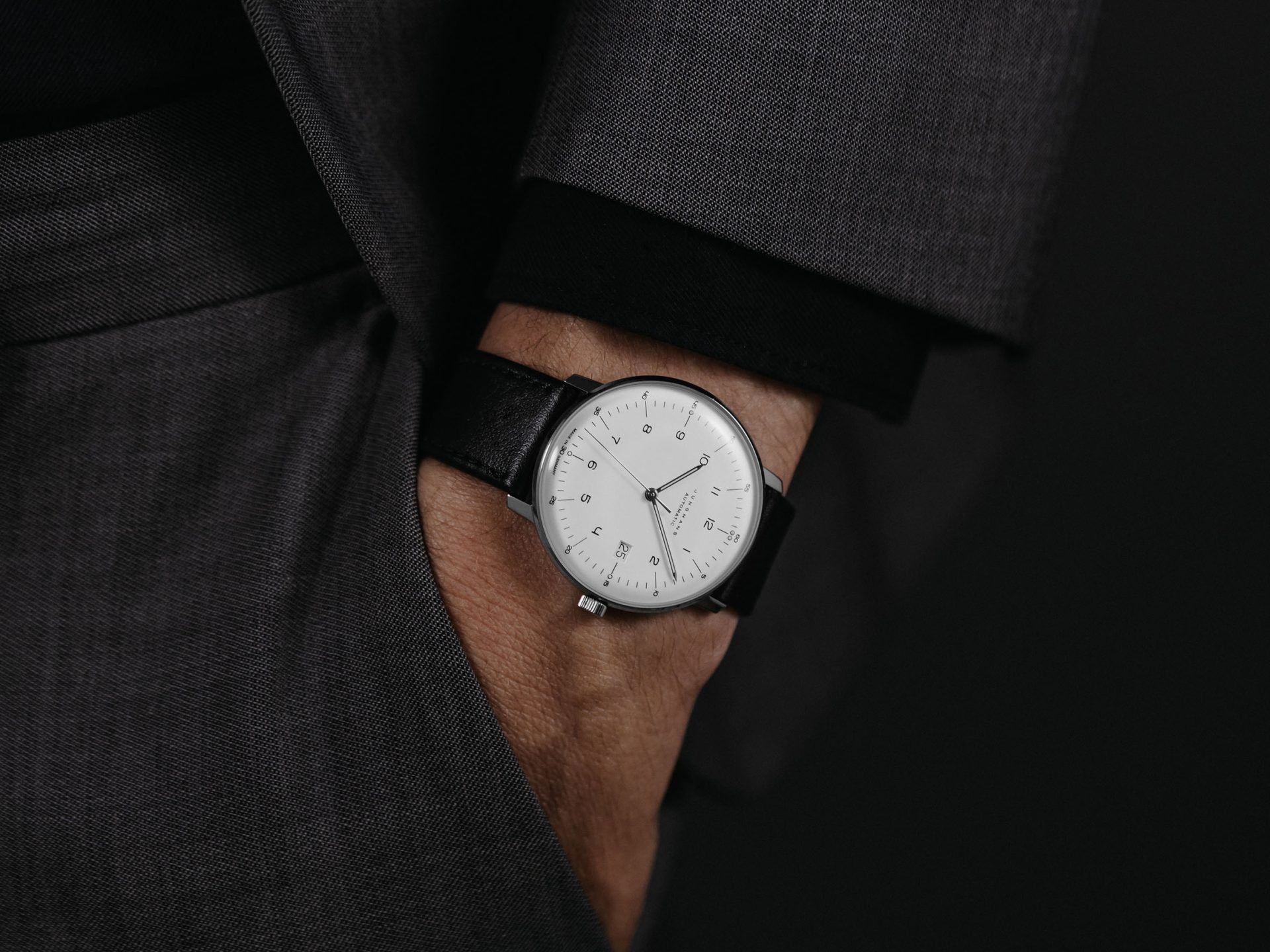 The silver-plated dial on wrist — the canonical max bill look