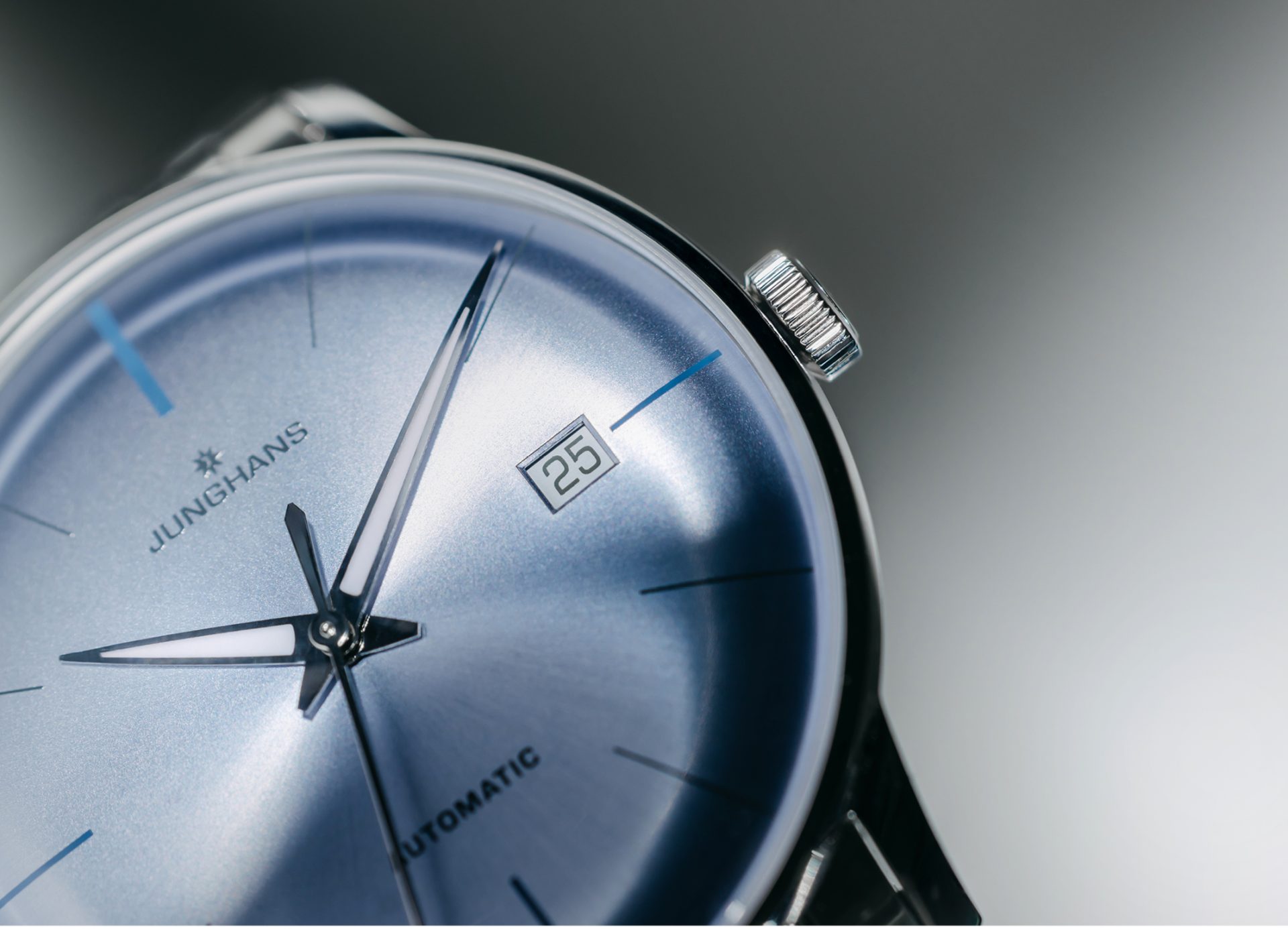 Macro view of the radial blue dial brushing and date aperture