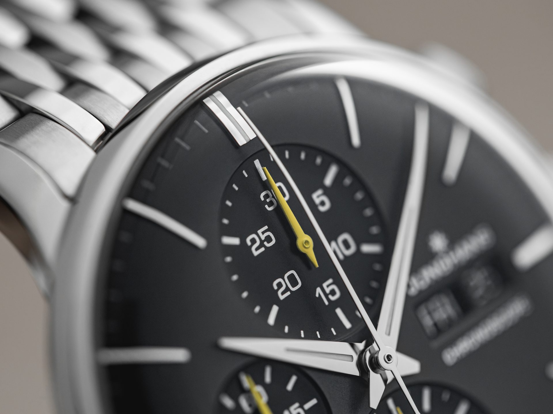 Close crop on the recessed subdial and lacquered yellow hand