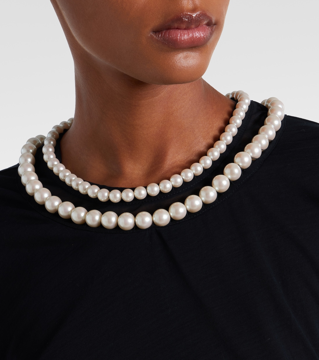 Close detail of the faux-pearl embellishment at the neck.