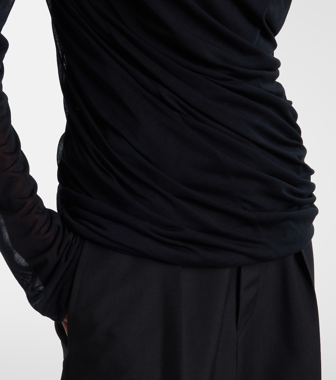 Ruched drape concentrated through the waist and hip.