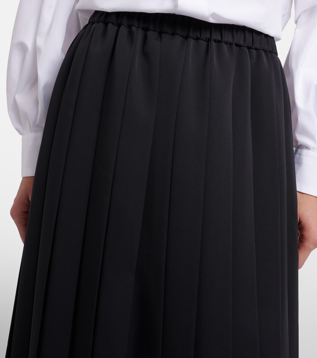 Close detail of the waistband and pleat structure.