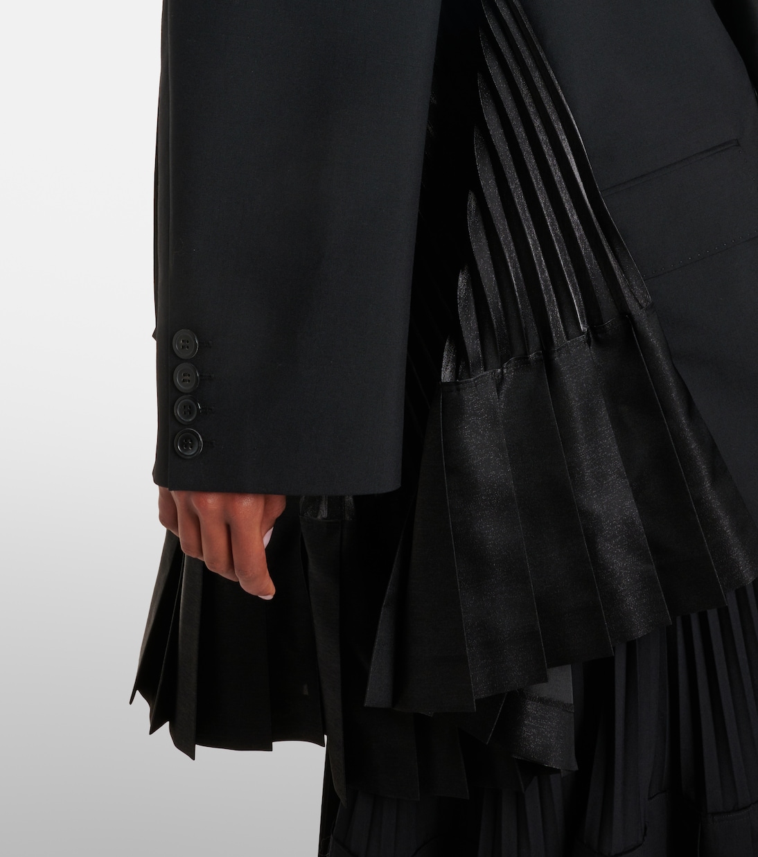 Textural closeup of the pleated panel work.