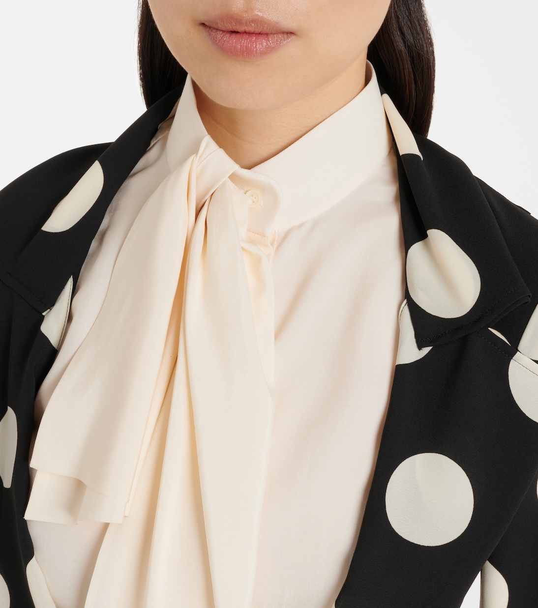 Detail of the scarf blouse framing the lapel and print scale.