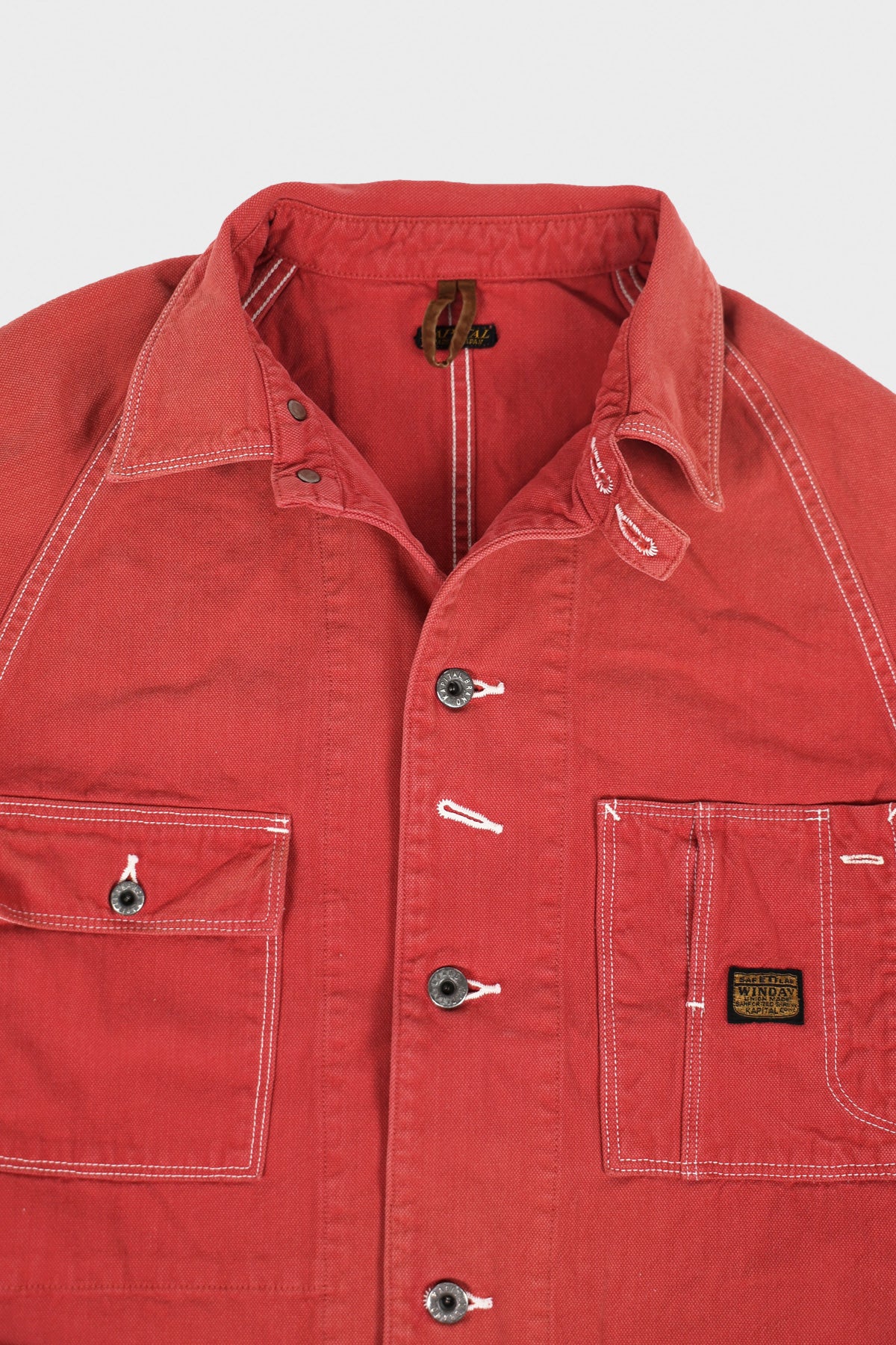 Rear utility pocket and broader chore-coat shape