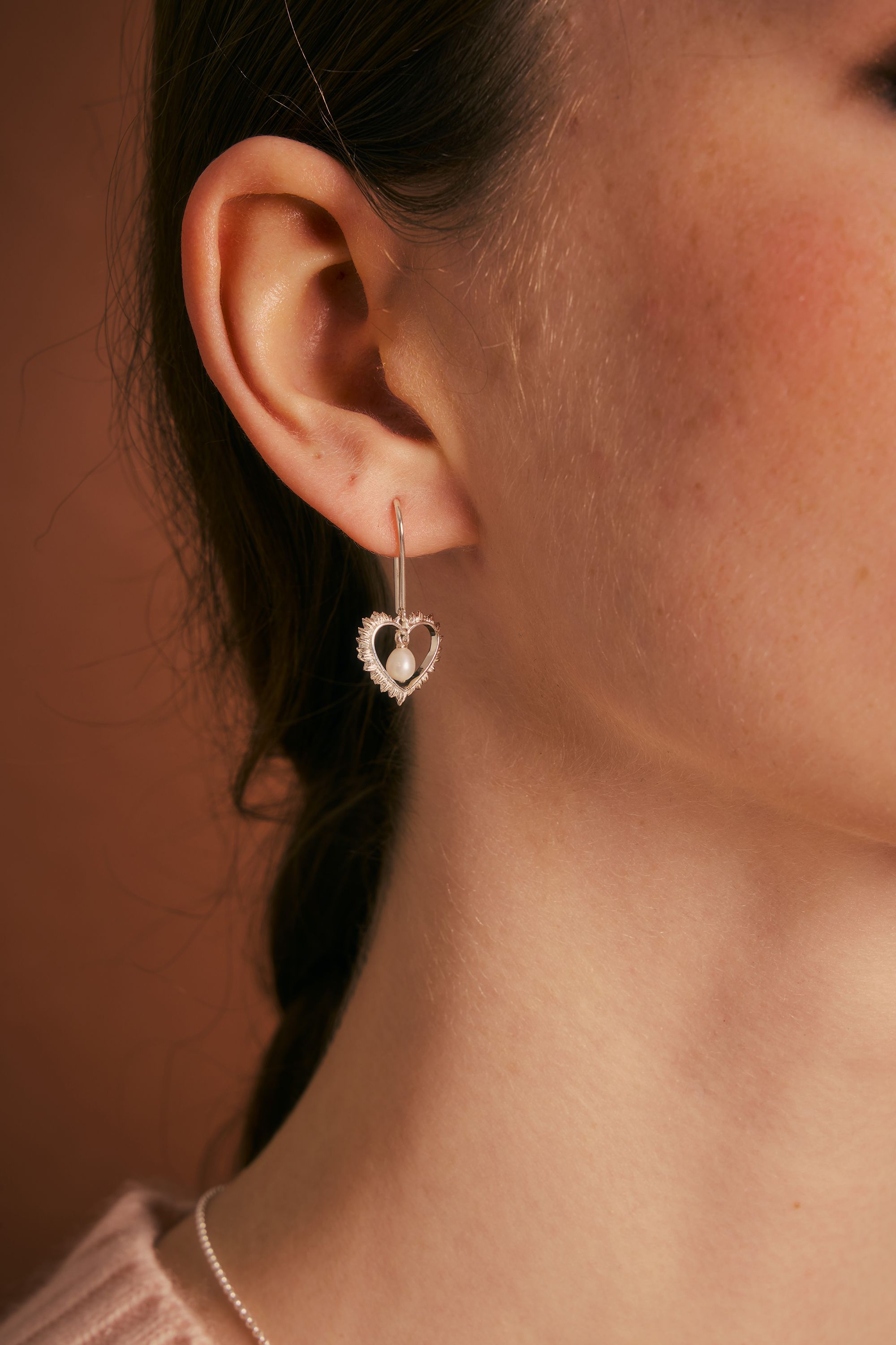 On-ear view of the Flaming Heart earrings
