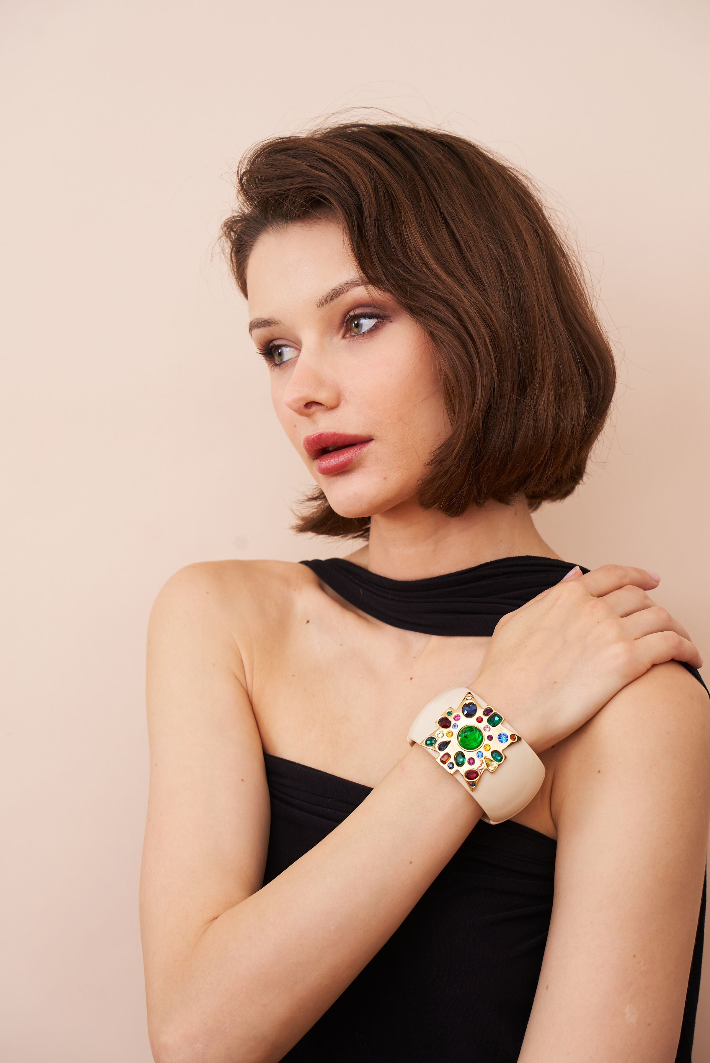 Styled portrait view emphasizing the bracelet as the outfit focal point