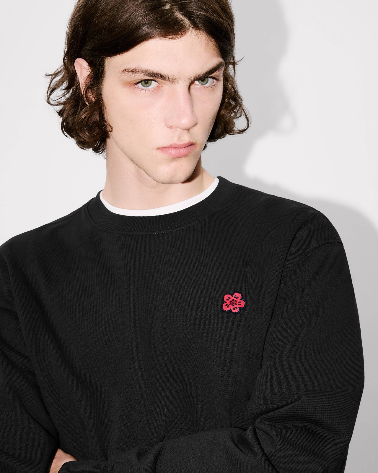 The embroidered Boke Flower crest, close on the chest