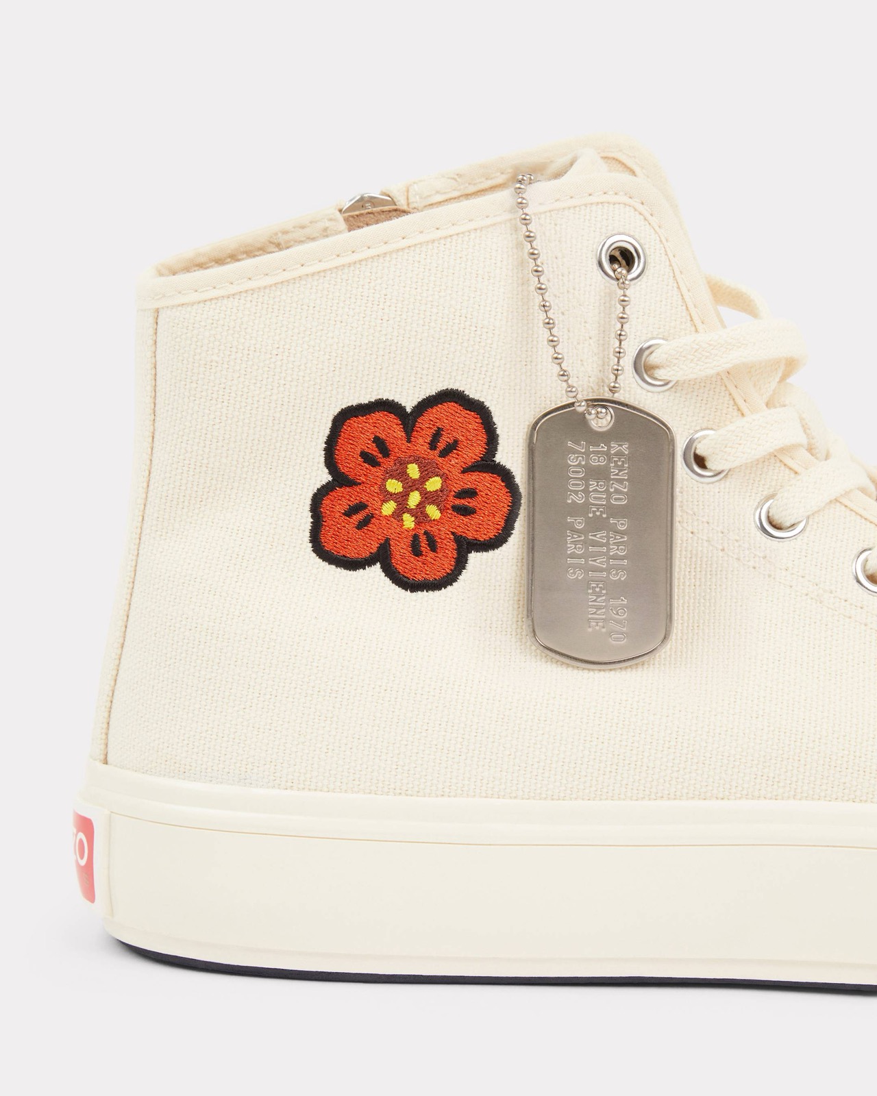The Boke Flower and engraved KENZO PARIS dog-tag, close