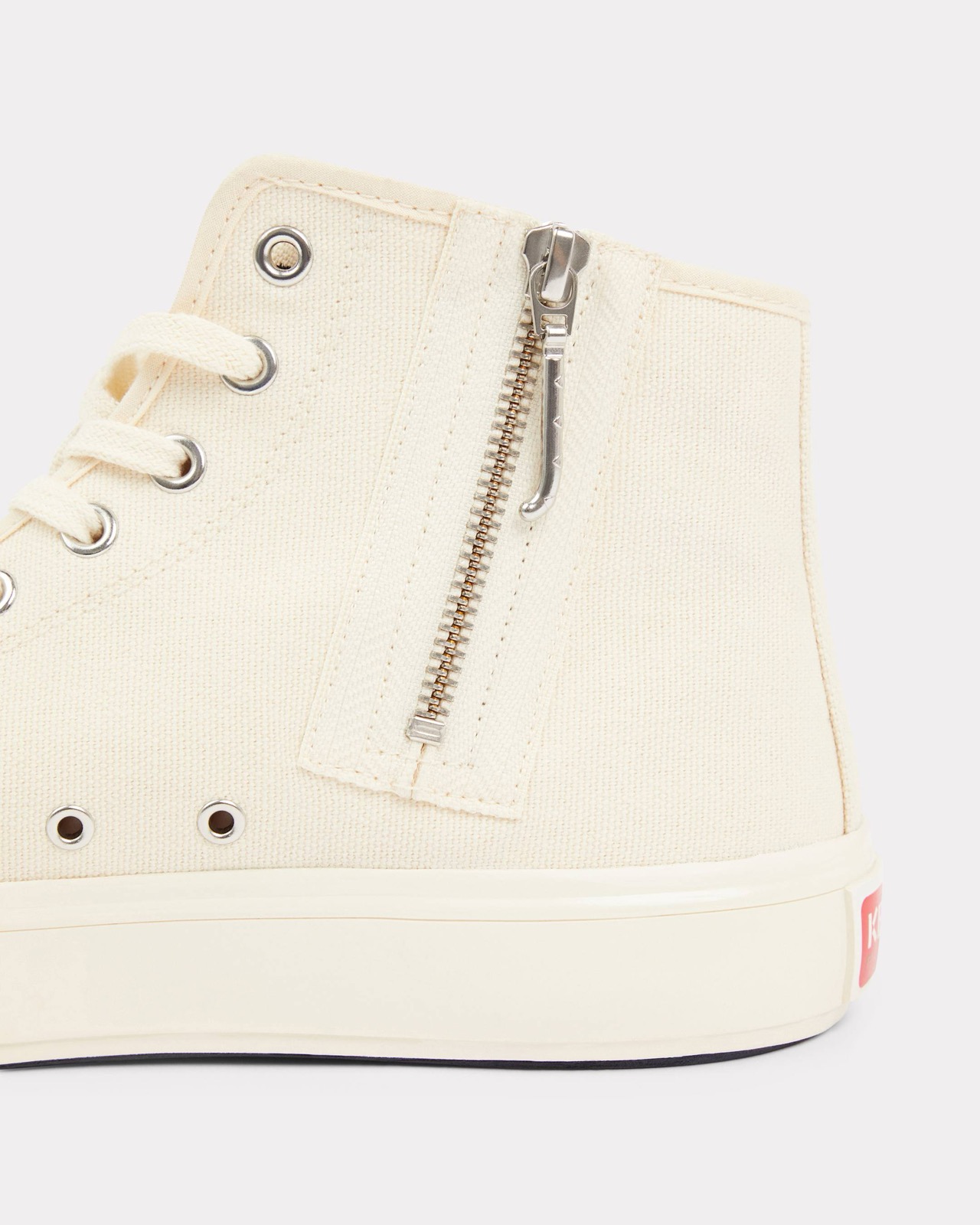 Side zip detail along the canvas upper