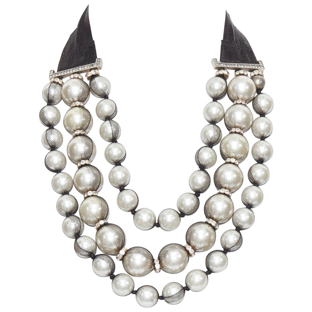 Multi-strand version — large tulle-wrapped pearls on black ribbon