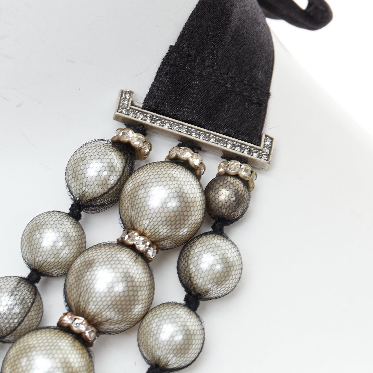 Detail of the tulle-wrapped pearls, crystal rondelles and ribbon tie