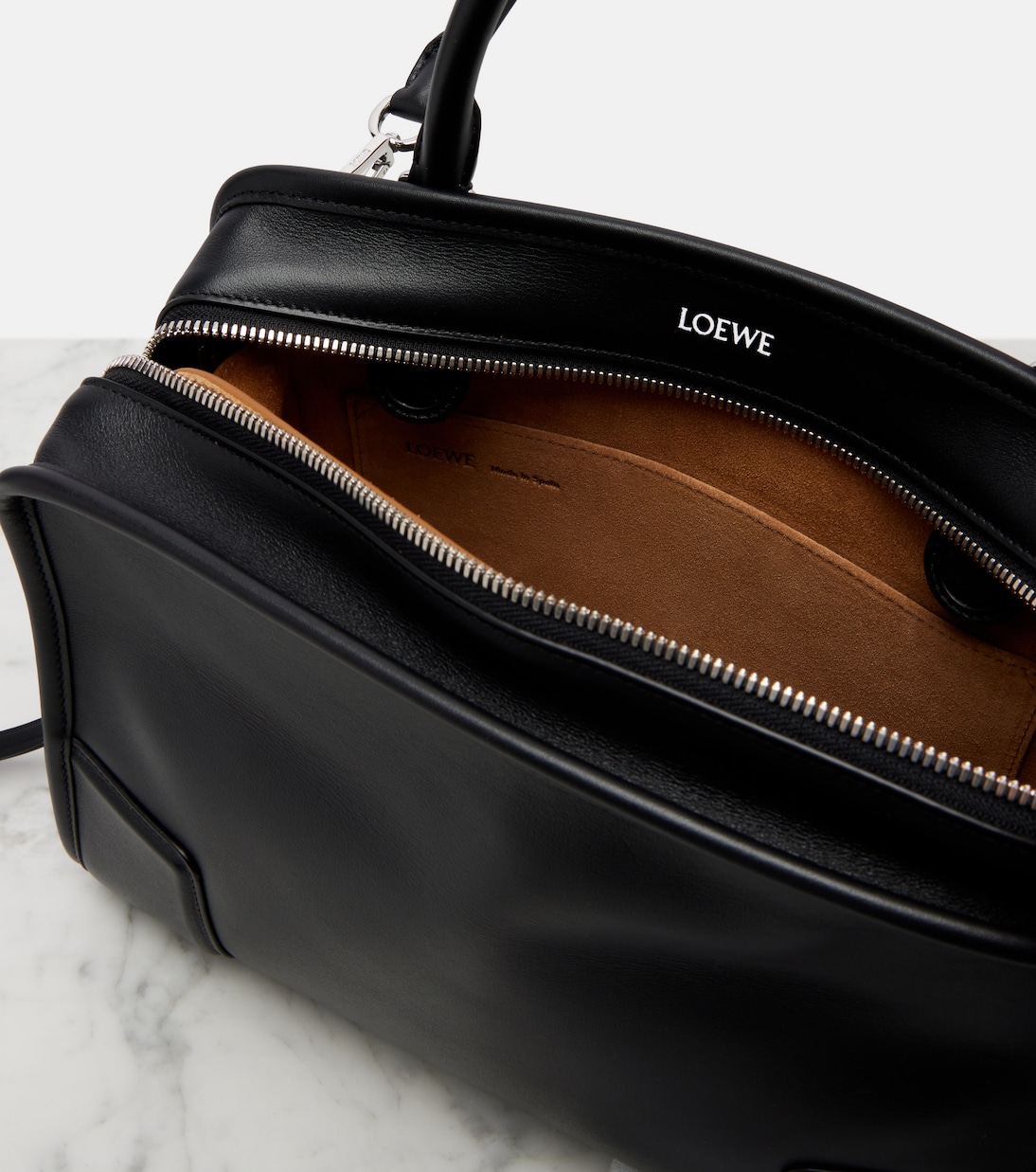 Profile view — the elongated base and bevelled corner tabs