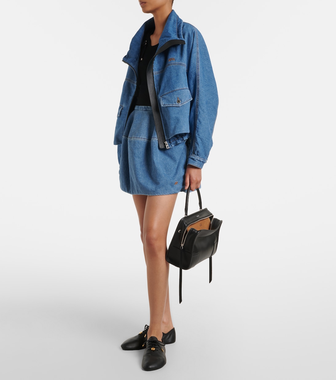 Top-handle carry — the single arched handle and LOEWE wordmark
