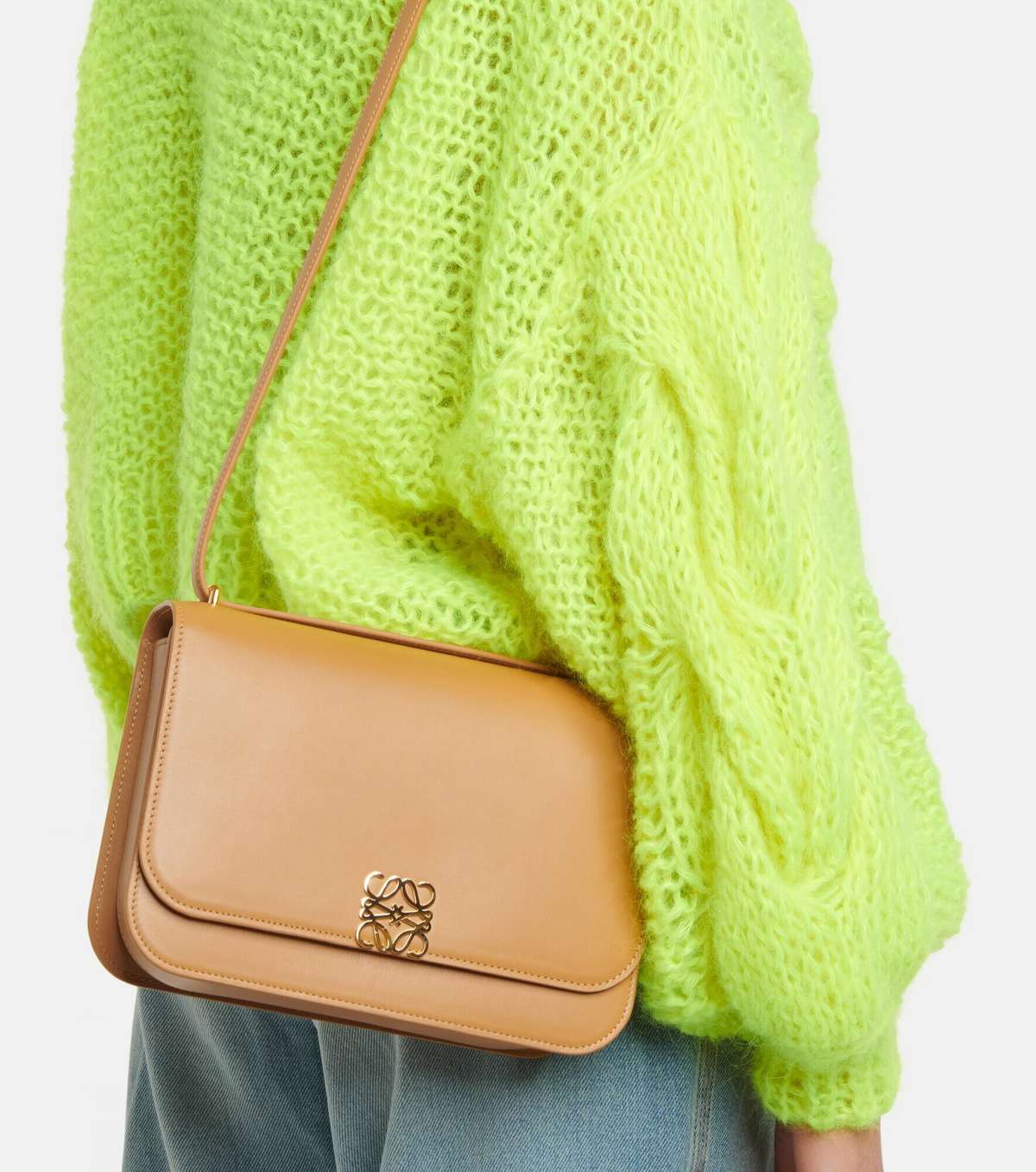 Profile view showing the curved base and shoulder strap attachment