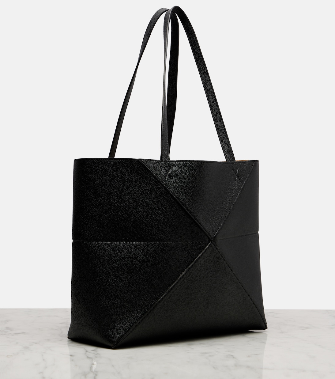 Flat-fold position — the bag collapses completely for travel