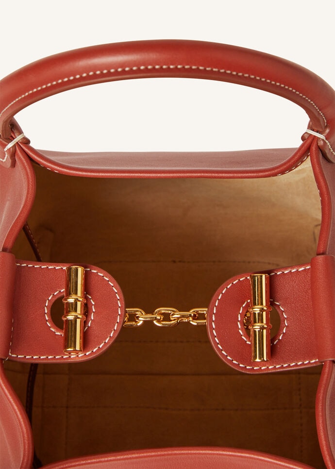 Open — the gold chain-and-toggle closure and suede interior