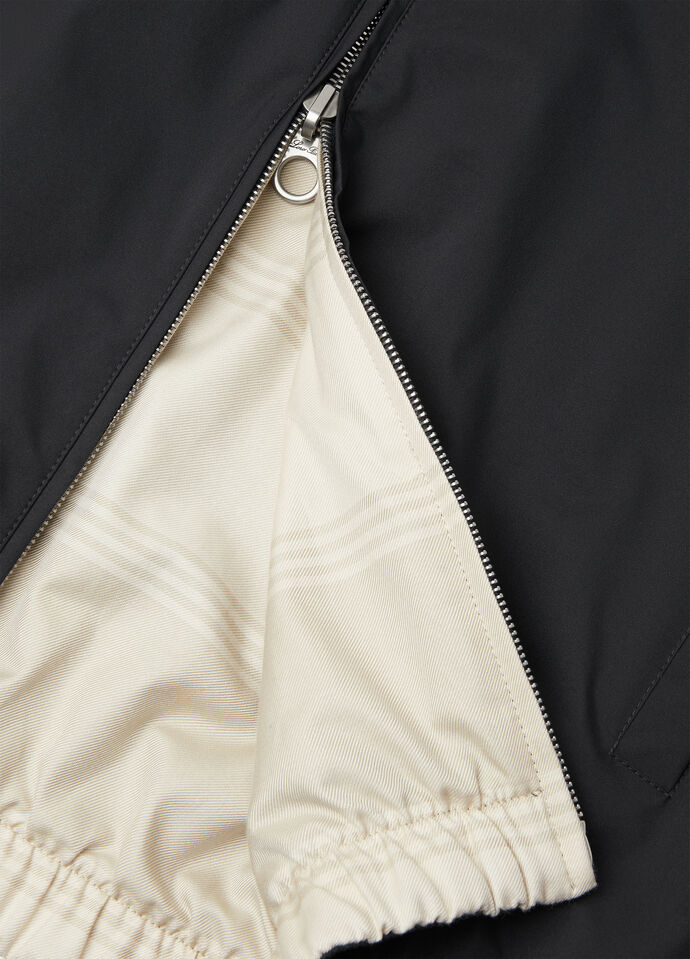 Detail — the engraved zip pull and beige reversible interior