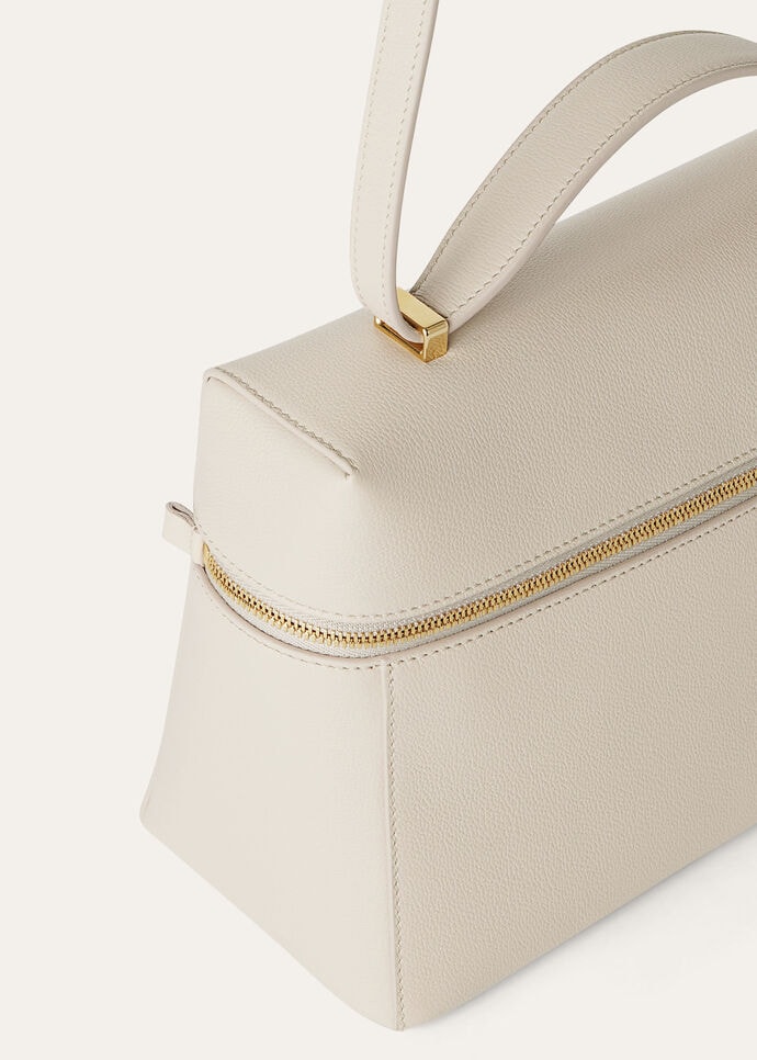 Detail of the grained calfskin and gold padlock