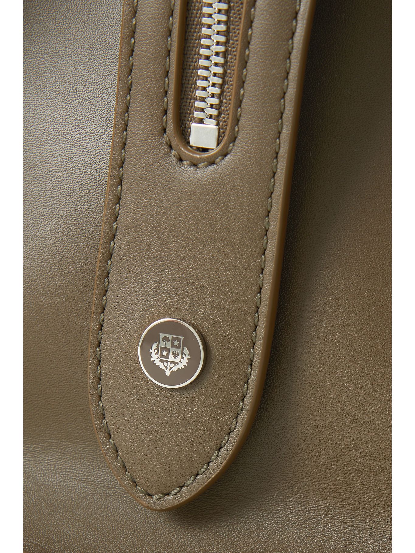 Detail of the silver Loro Piana crest stud and curved panel