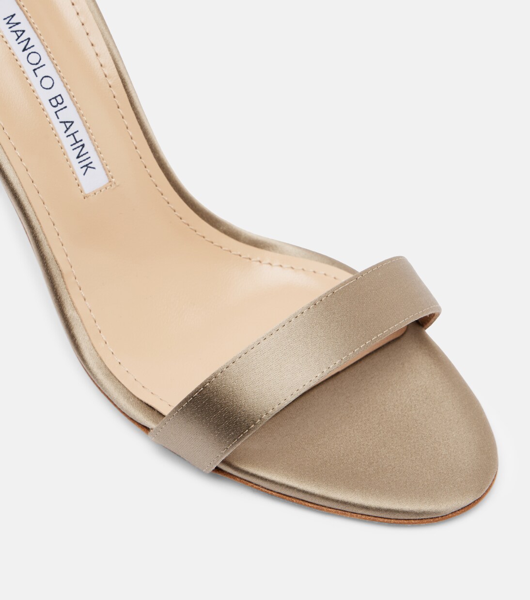 Close-up of the front strap in beige satin
