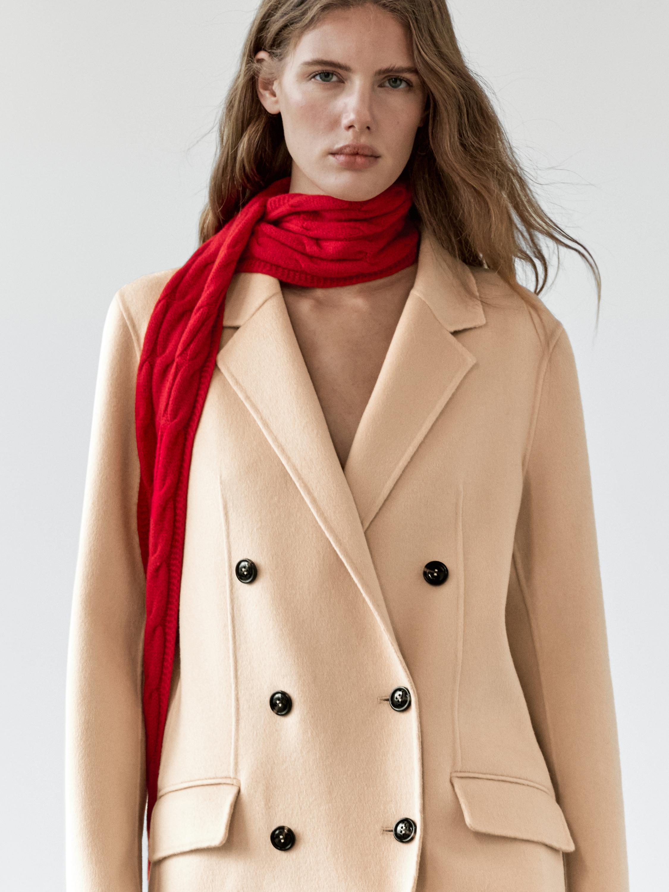 Close portrait crop showing the lapel and button stance