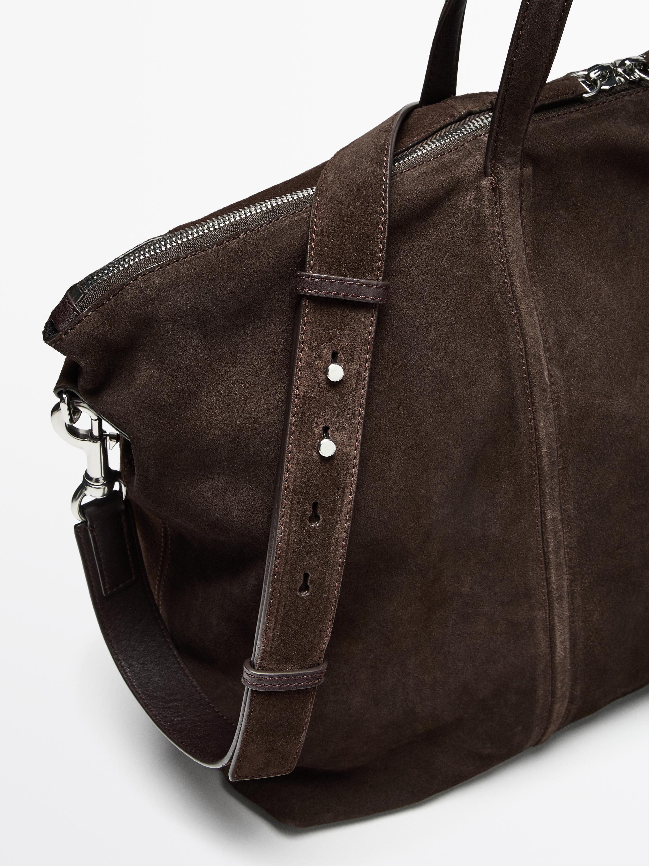 Detail crop showing the strap, zipper, and seam construction