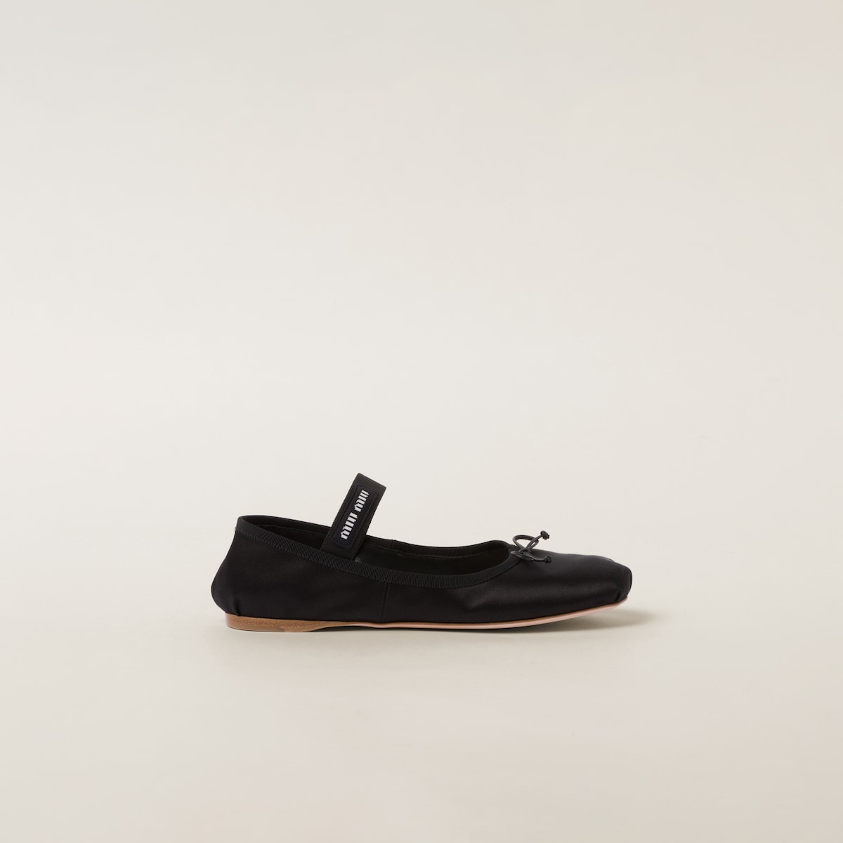 Rear three-quarter — the gathered heel and slim leather sole