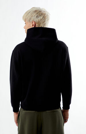 Back view — the hoodie sits boxy and easy over wider pants.