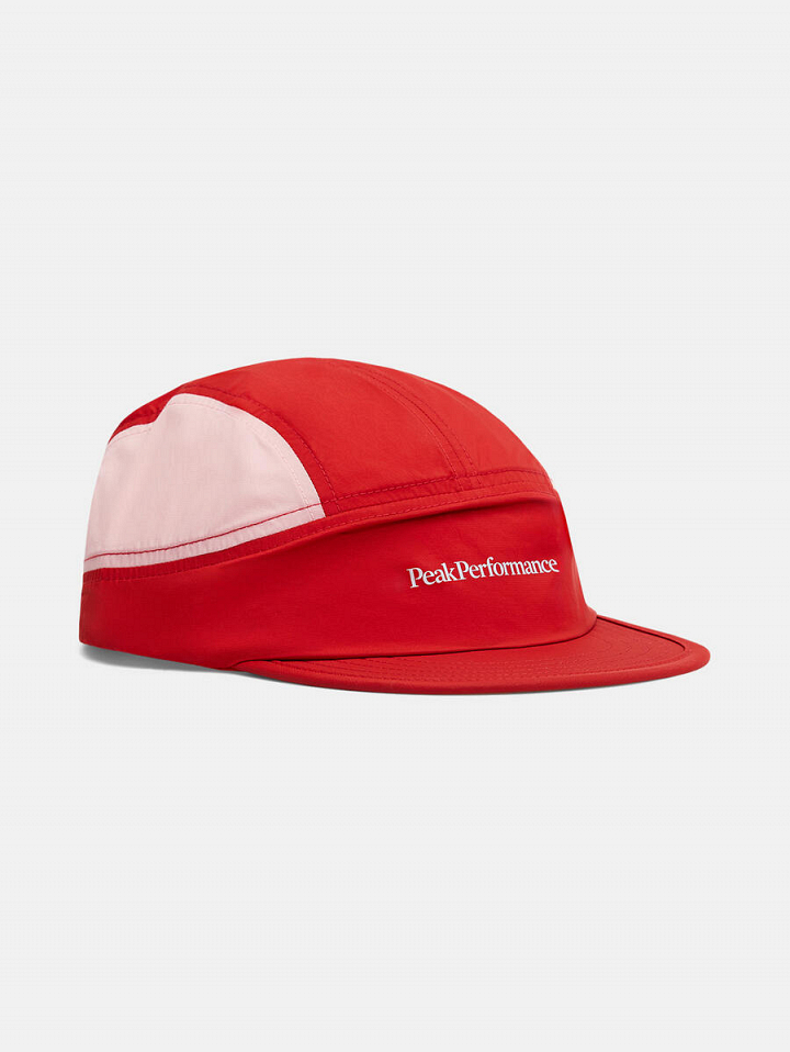 Red five-panel cap with a short brim and a white side panel, shown in side view; white text reading “PeakPerformance” on the side.