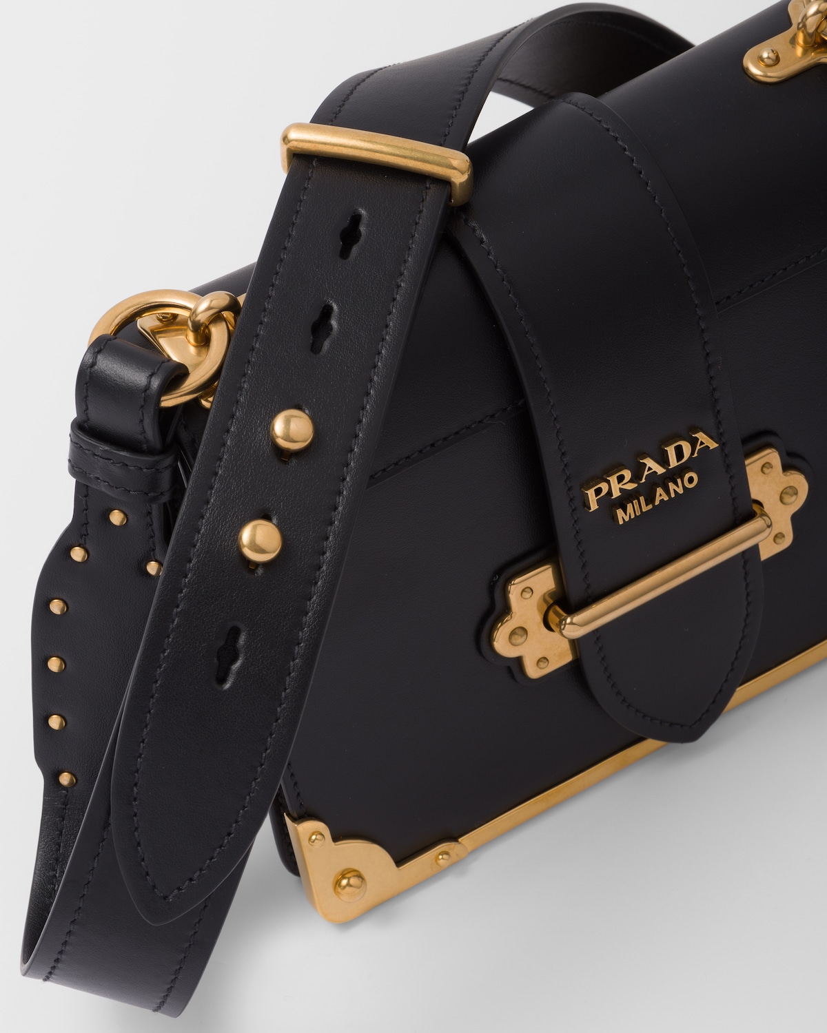 Closeup of the antiqued metal corner hardware and PRADA MILANO clasp